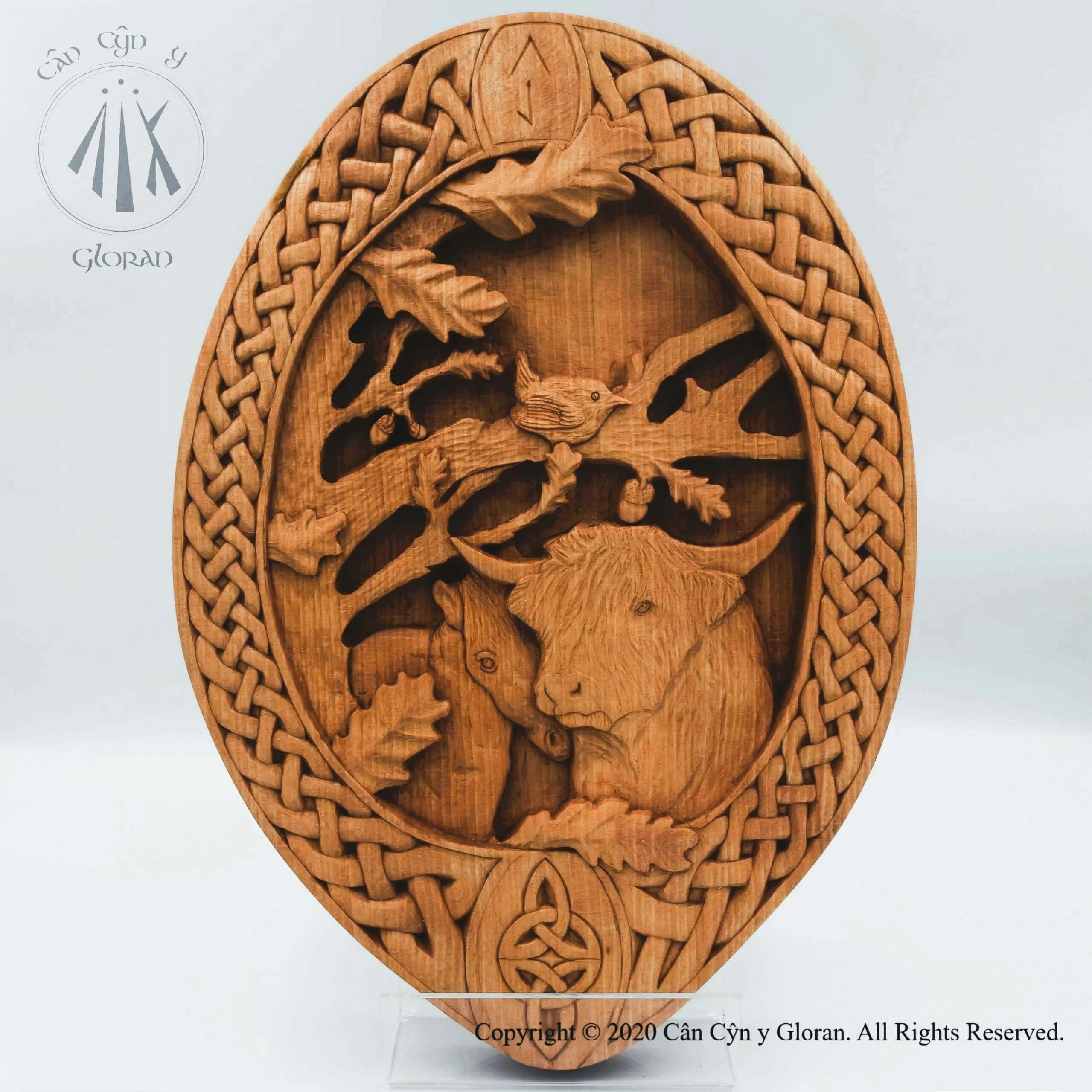 Beech carving by Cân Cŷn y Gloran: highland cow, wren, oak tree, horse, celtic knotwork border.