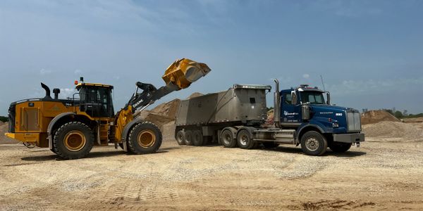 Truck being loaded with gravel materials.