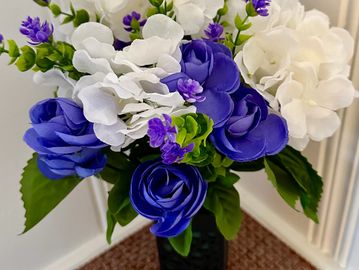 Purple and white flower in black lace cemetary vase for grave markers, mothers day