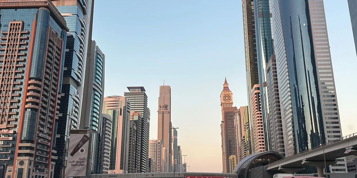 Modern city skyline with tall skyscrapers under a clear sky.