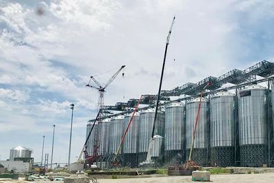 Technicians performing insulated metal panel installation on structure.