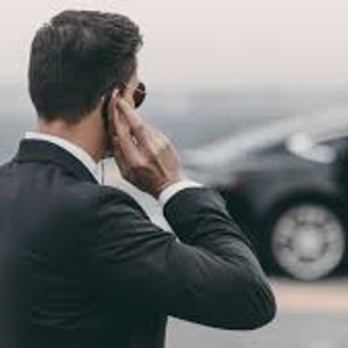 Man in suit using a phone.