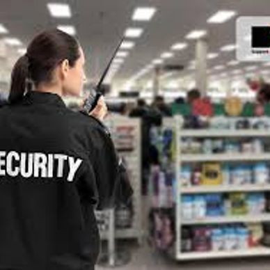 Security guard monitoring a store with a walkie-talkie.