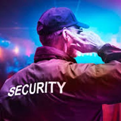 Security guard communicating via earpiece at an event.