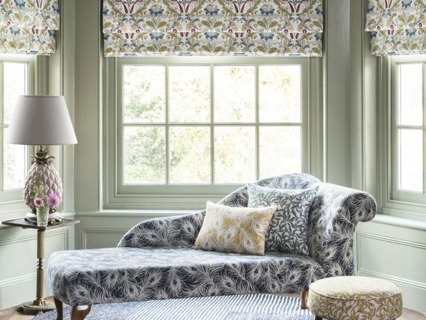 Made to measure roman blinds in a bay window with matching upholstery, cushions, seating pads