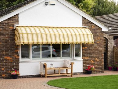 Striped awning covering large window 