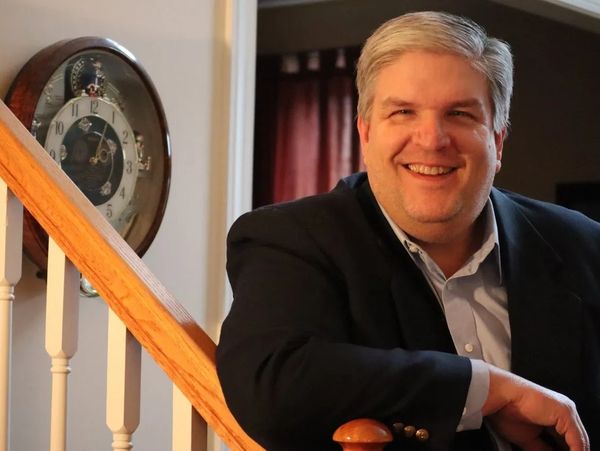 Accountant standing at a stairway, smiling