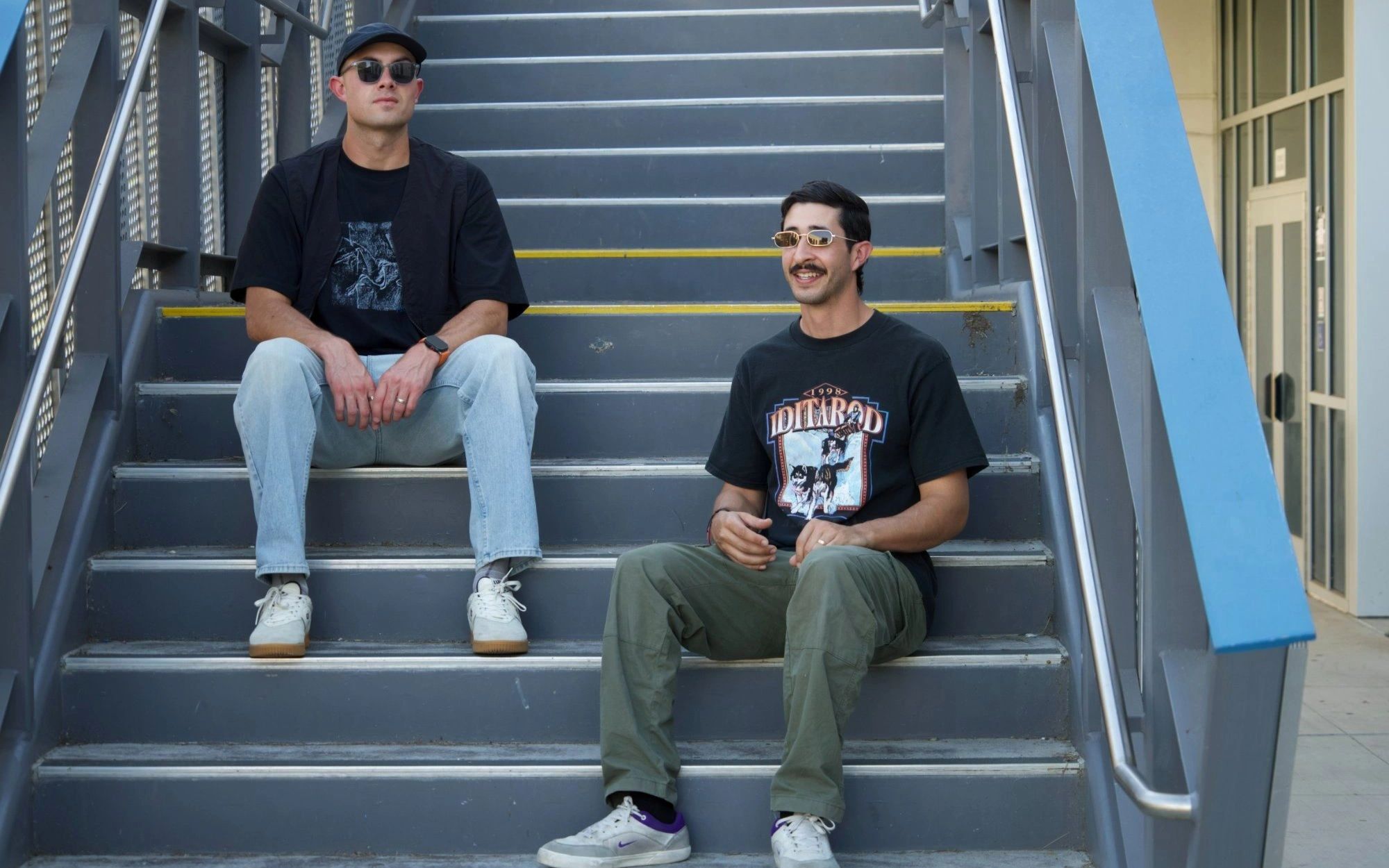 VILLIN, tech house and indie dance DJ duo, sitting on a staircase in Los Angeles