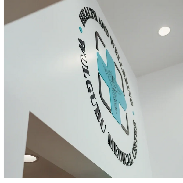 Logo of Health and Wellbeing Wulguru's new medical center in Townsville on interior wall. 