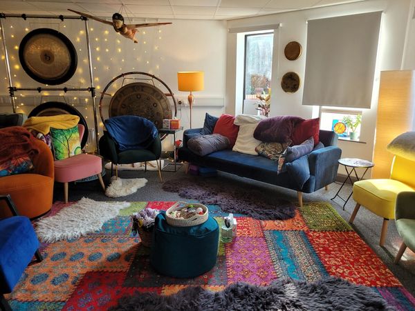 Comfy sofas and chairs in the group room at The Sand & Sound Centre