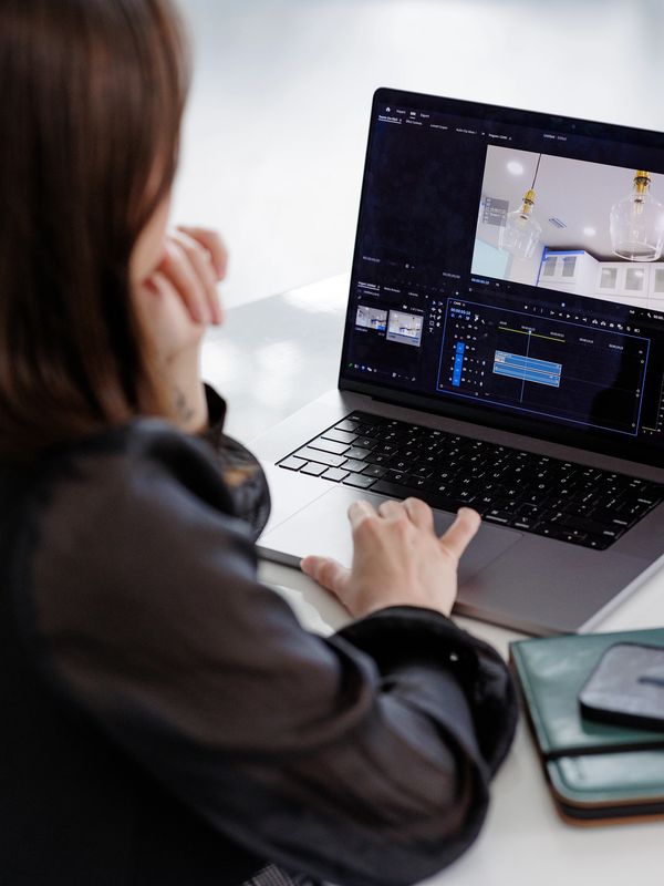 Person editing video on laptop.