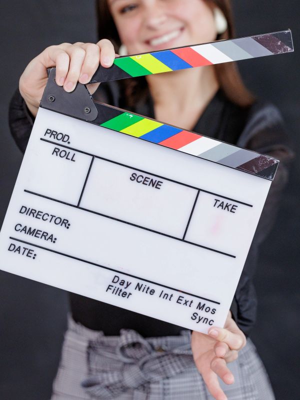 Person holding a film clapperboard.