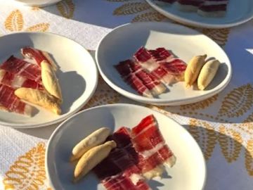 Jamon Iberico slices served with picos, Spanish tapas crackers.