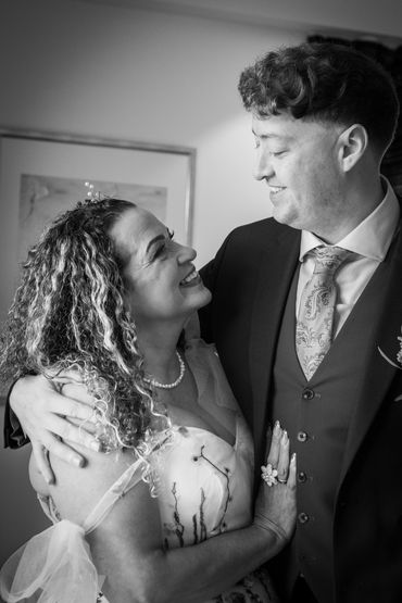 Couple sharing a joyful moment, smiling warmly at each other.