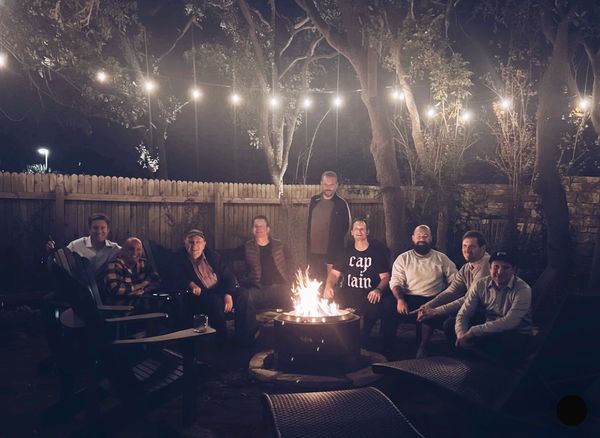 Council Fire Members around a fire. 