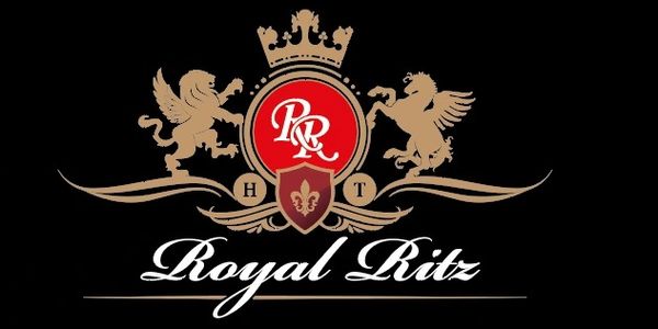 Royal Ritz logo with crown, lion, and griffin on black background.
