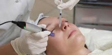 Woman receiving a facial cosmetic treatment with medical instruments.