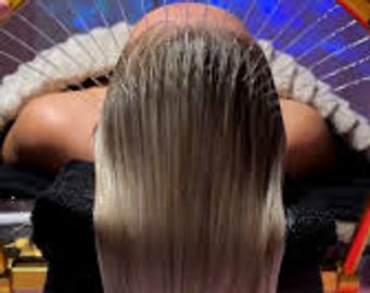 Top view of a person with long, wet hair under a shower.