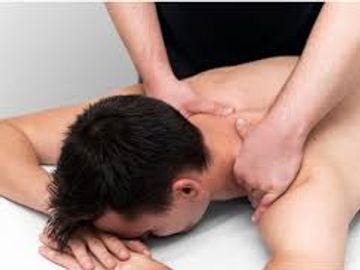 Person receiving a shoulder massage from a therapist.