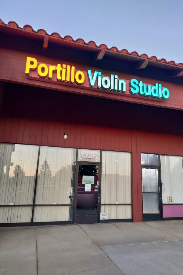 Portillo Violin Studio storefront with lit up sign