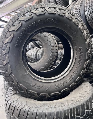 Close-up of stacked off-road tires with Yokohama branding.