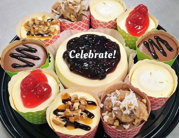 Gift Box- personal cheesecake surrounded by 10 mini cheesecakes presented in a clear dome container.
