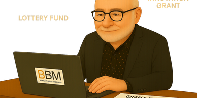 Man at laptop with grant award approved.