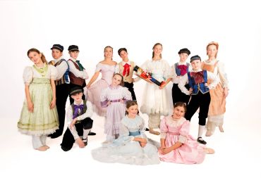 Group of children in colorful traditional costumes posing together.