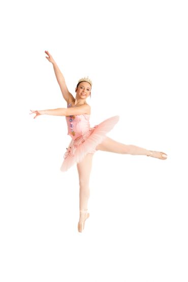 Ballet dancer in pink tutu performing a graceful arabesque pose.