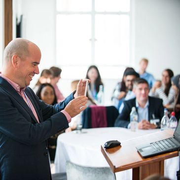 Neil Callen, of The Coaching Cycle, takes a photograph of a group of people with his phone