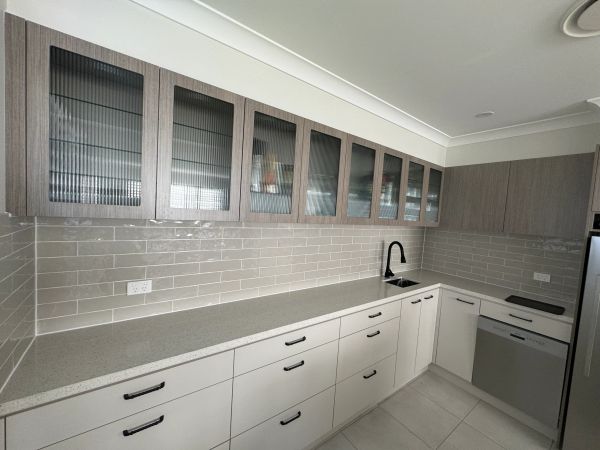 Modern kitchen with sleek cabinets and appliances.