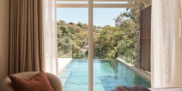 View of a private pool through sliding glass doors.