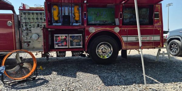 Tailgate setup with TV screens on a truck.
