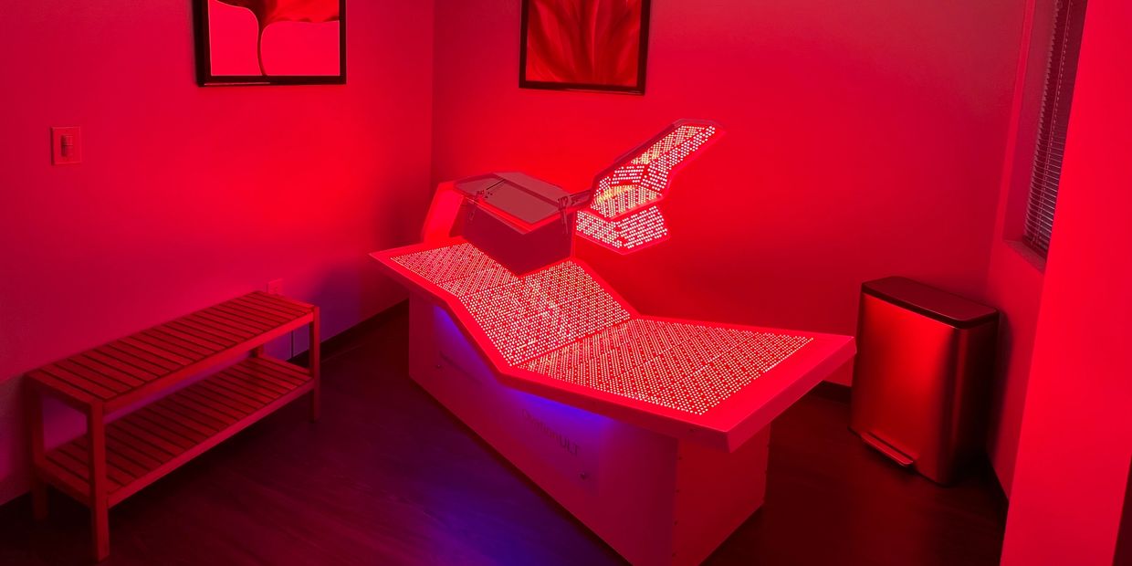 Our state-of-the-art Red Light bed, powered on, in its designated treatment space.