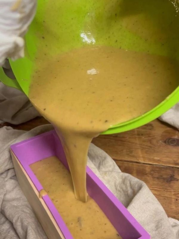 Pouring batter into loaf pan.