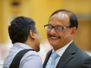 Two men sharing a joyful moment during a conversation.