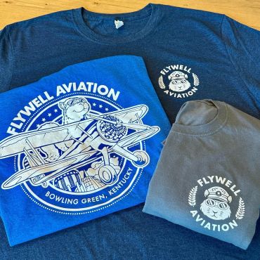Flywell Aviation branded t-shirts with aviation-themed designs.