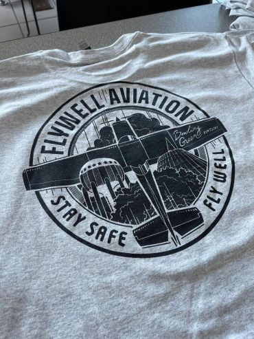 Gray T-shirt with aviation-themed logo and text.