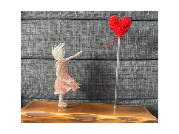 Wire girl with balloon wire sculpture