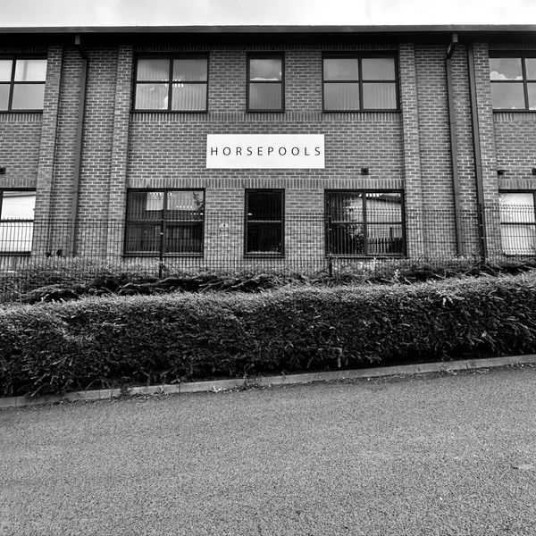 Brick building with a sign saying HORSEPOOLS.
