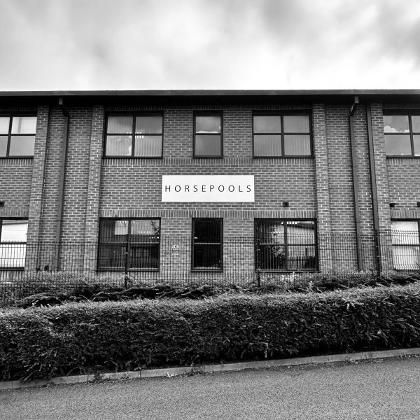 Brick building with a sign saying HORSEPOOLS.