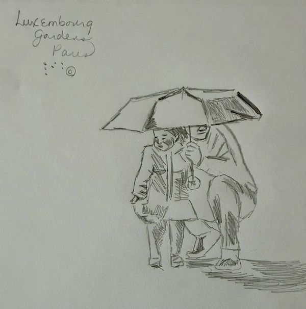 Young child hidden under an umbrella with her father on a rainy day.