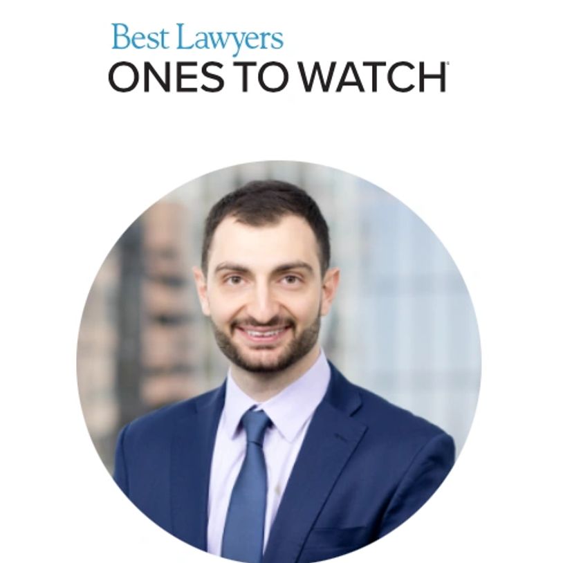 Professional portrait of a young lawyer in a suit and tie.