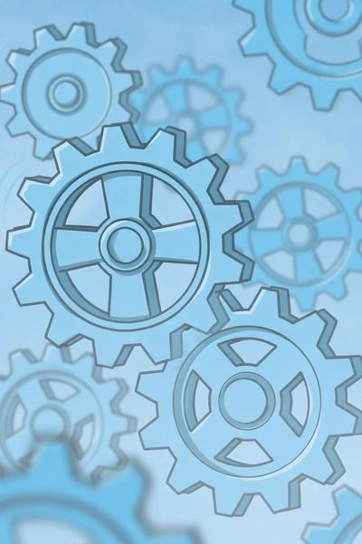 Blue gears interlocking on a light blue background.