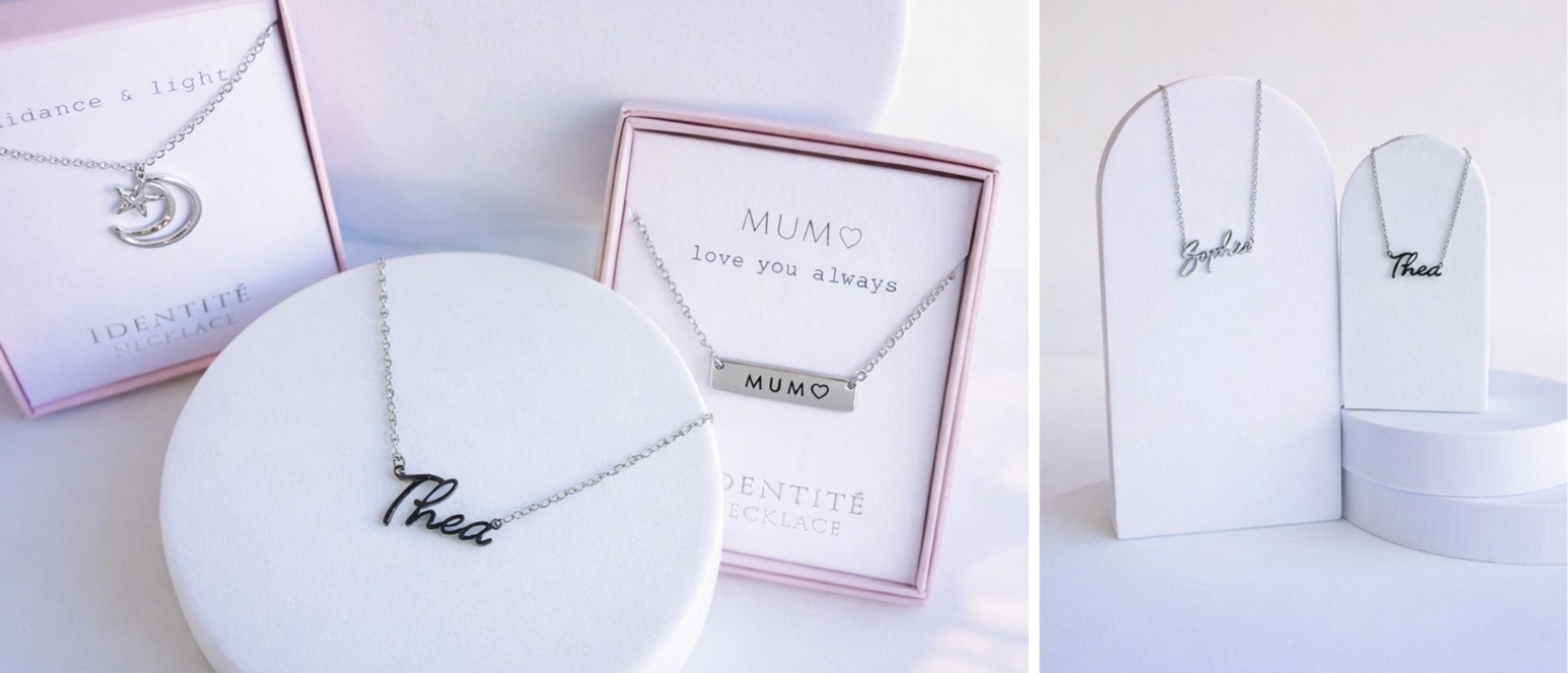 Elegant personalized name and message necklaces displayed on white stands and boxes.