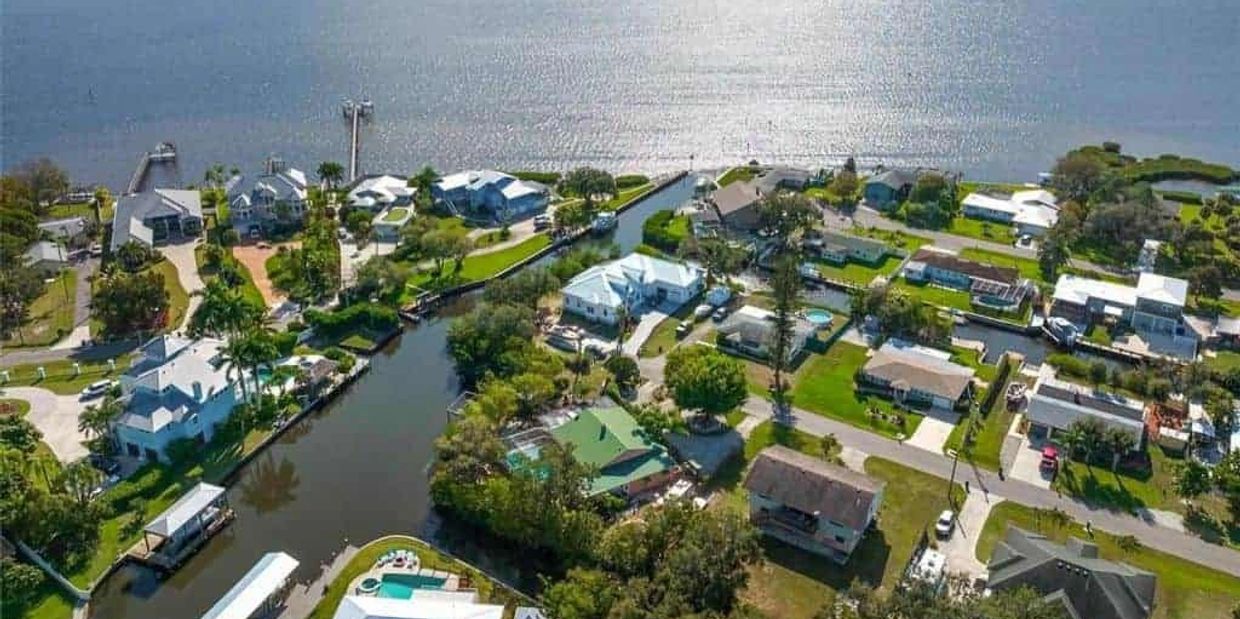 A waterfront neighborhood with canals and houses by the water.