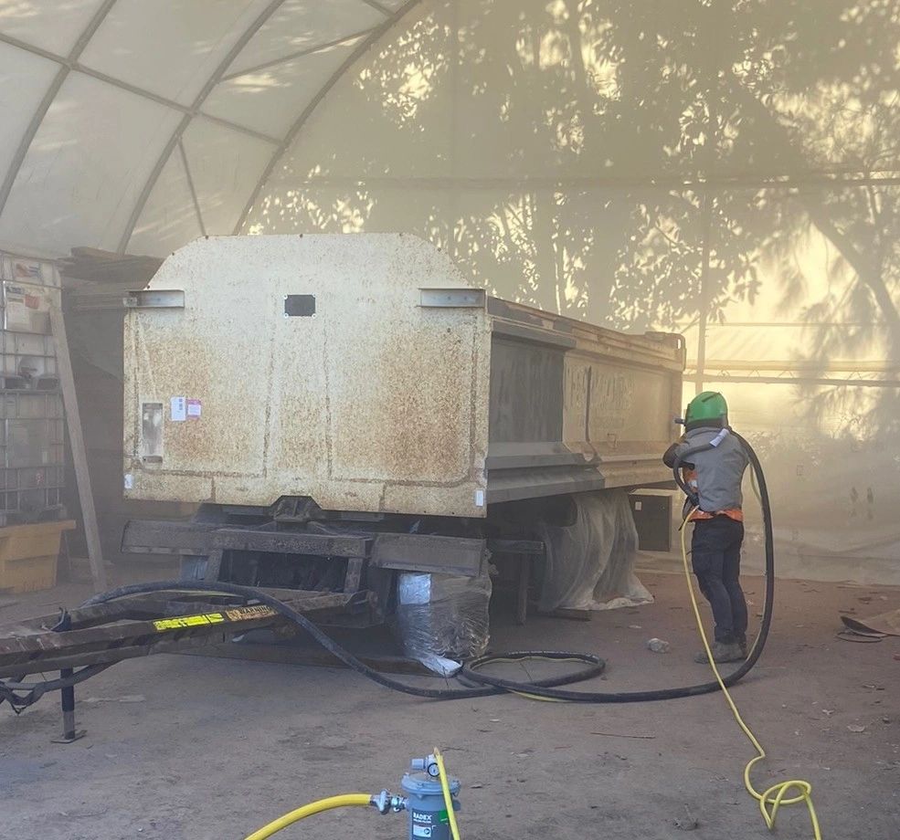 A dog trailer in the process of getting sandblasted