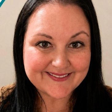 Smiling woman with long black hair.