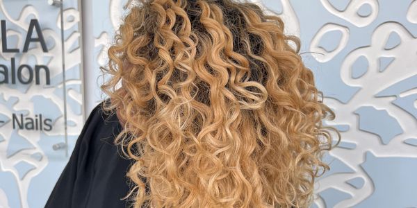 Beautiful honey blond highlights on curly hair.