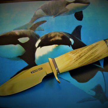 Custom handmade knives with different blades and a large assortment of handle materials